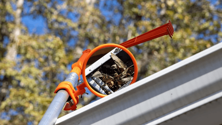 Traditional gutter cleaner using a gutter cleaning tool with a ladder