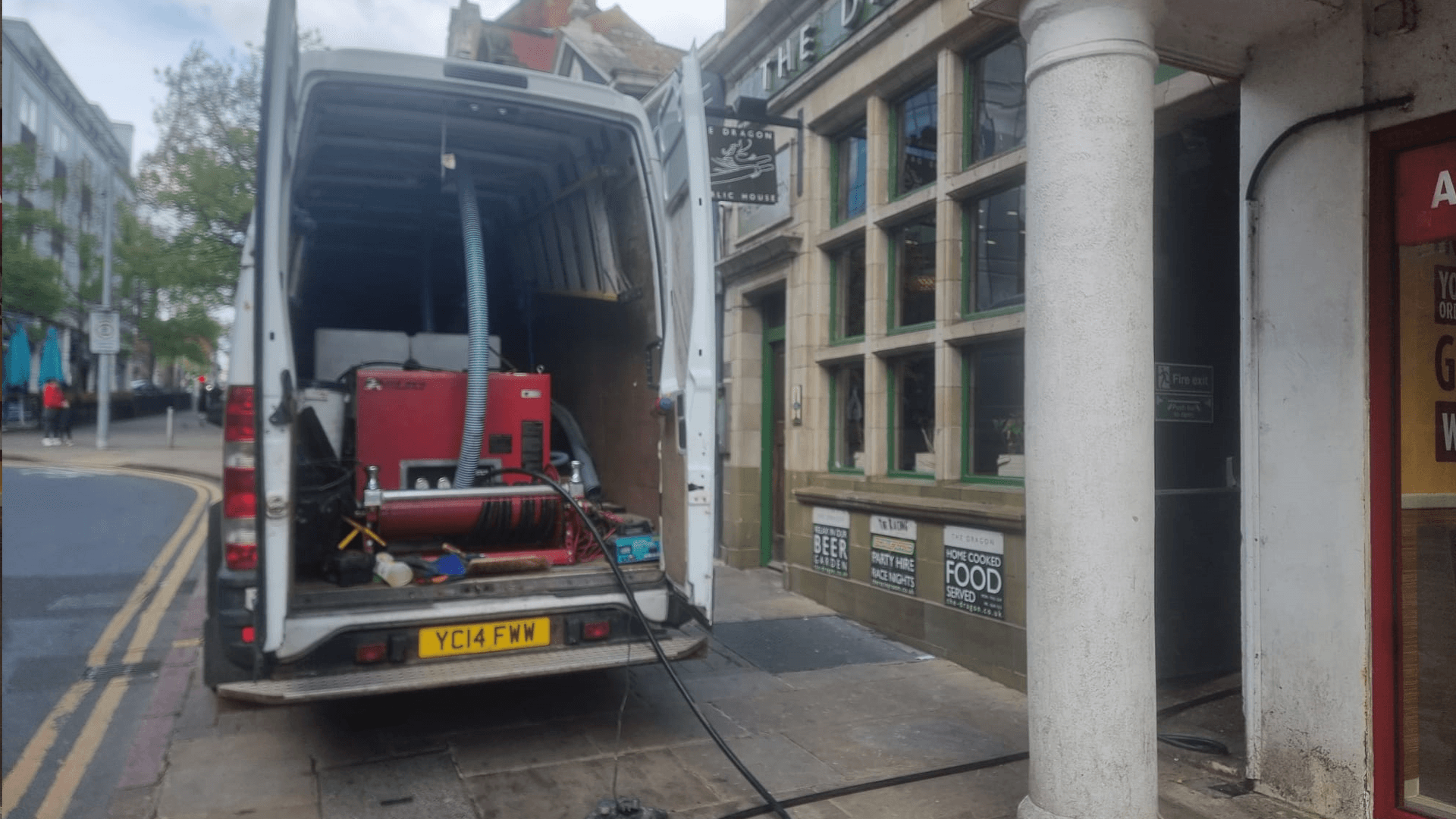 A photo of a drain jetter inside a commercial drainage van