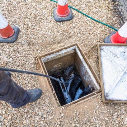 A photo of a Budget Drains Nottingham Engineer investigating a blocked drain