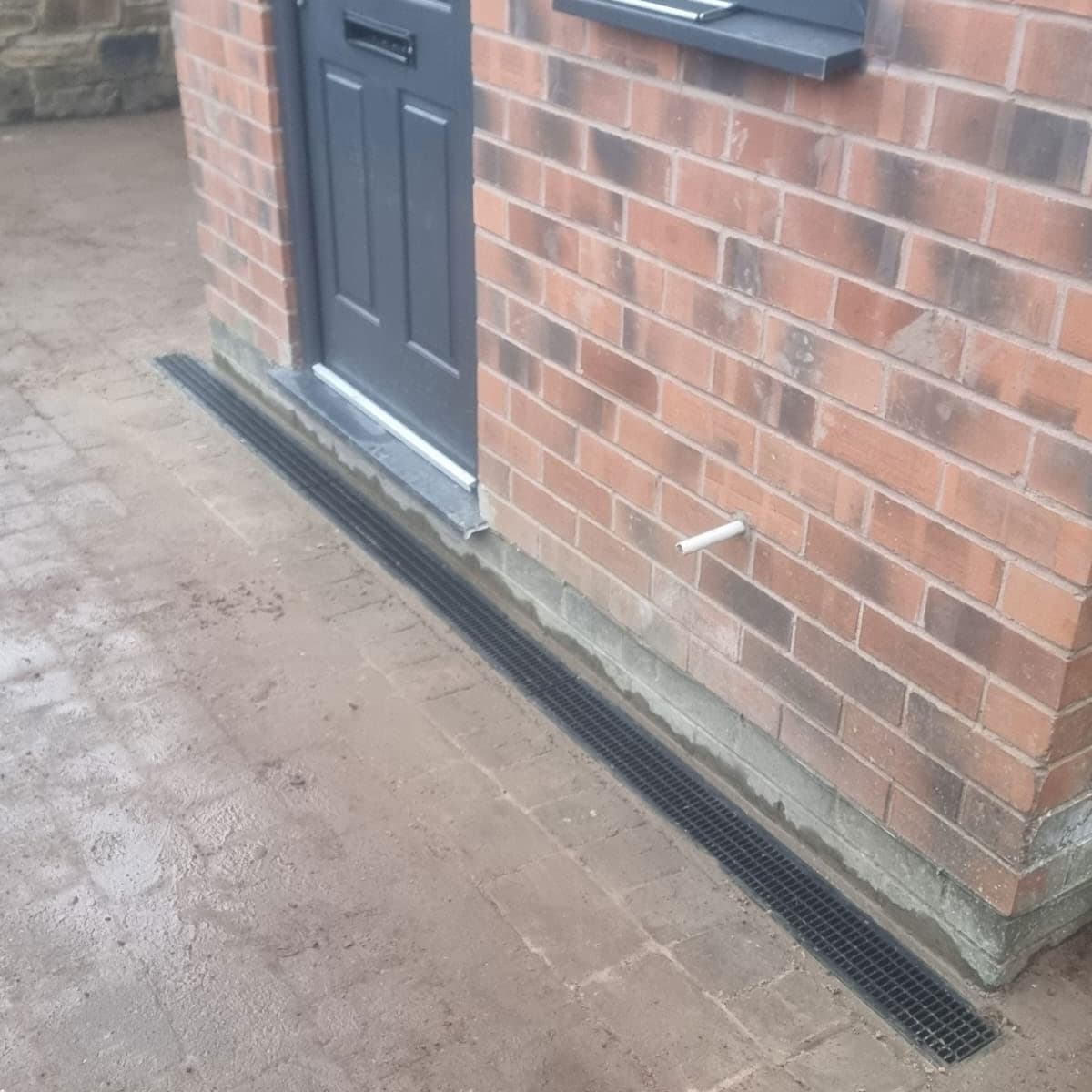 A Photo of channel drain install and cleaning for a happy customer