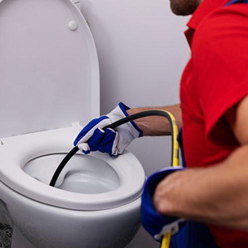 A Budget Drains Nottingham toilet unblocking team member unblocking a toilet with a jetter